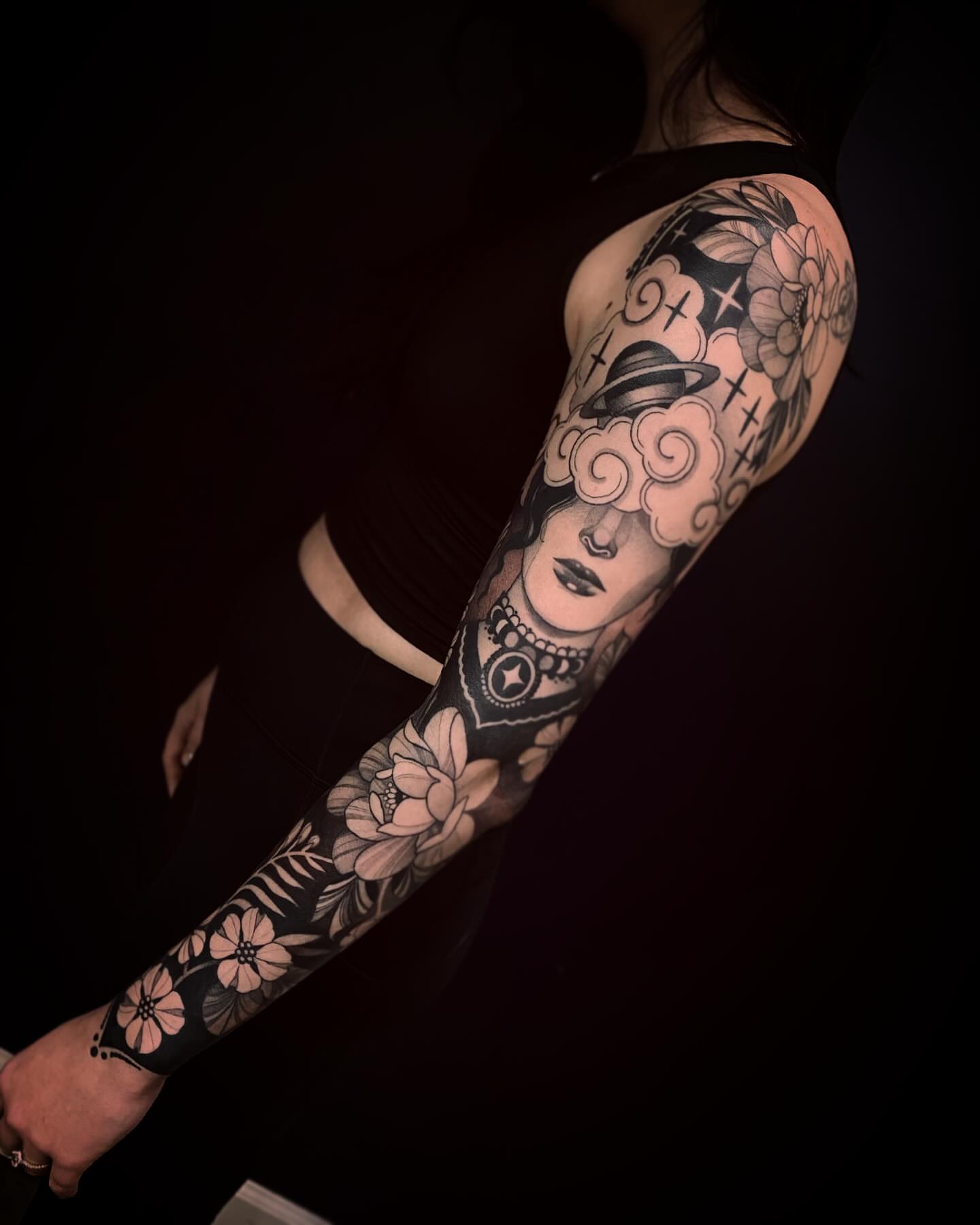 Portrait with flowers American traditional tattoo on the upper arm by Natasha Dickinson