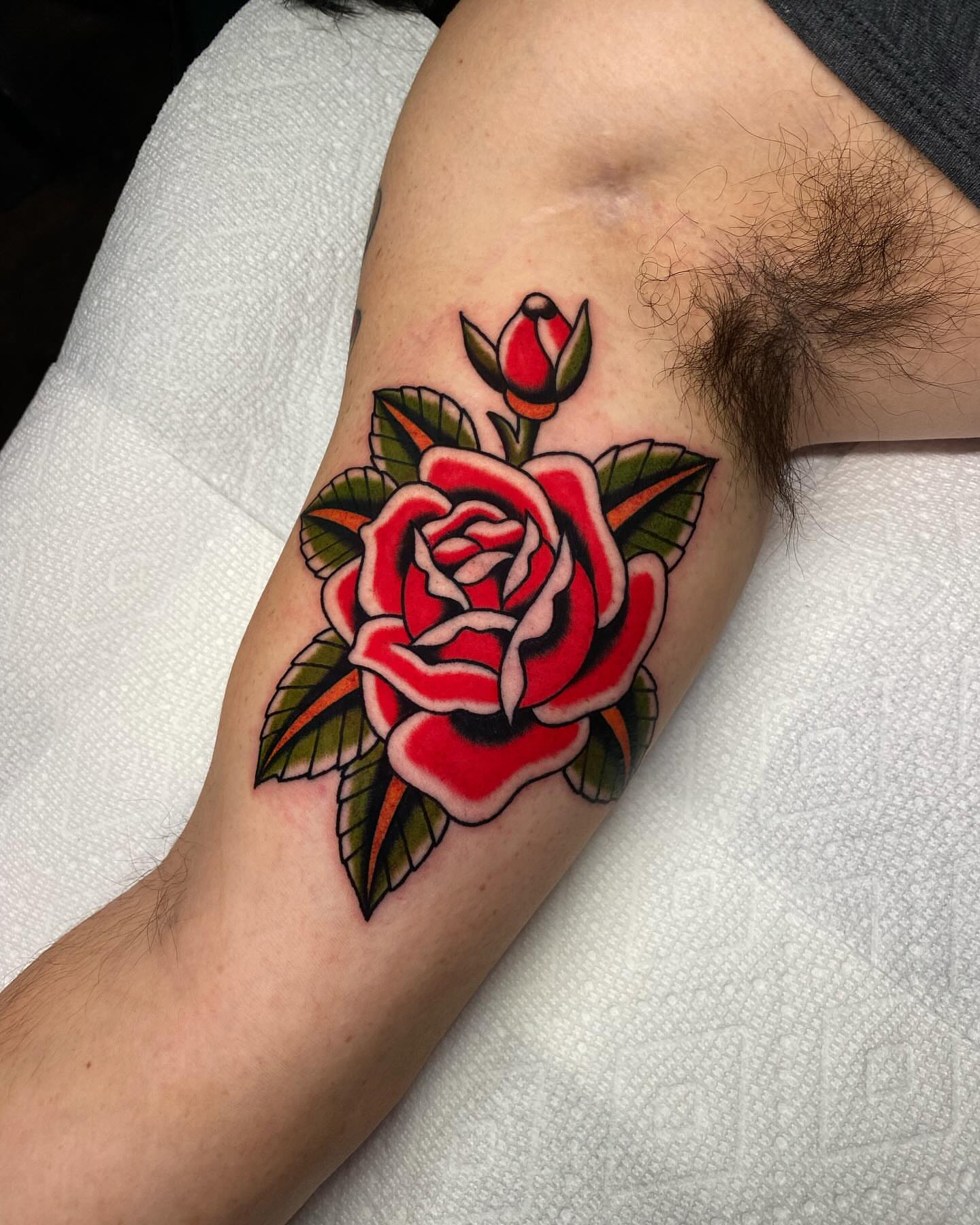 Red rose American traditional tattoo on the forearm by Mitch Hoggard