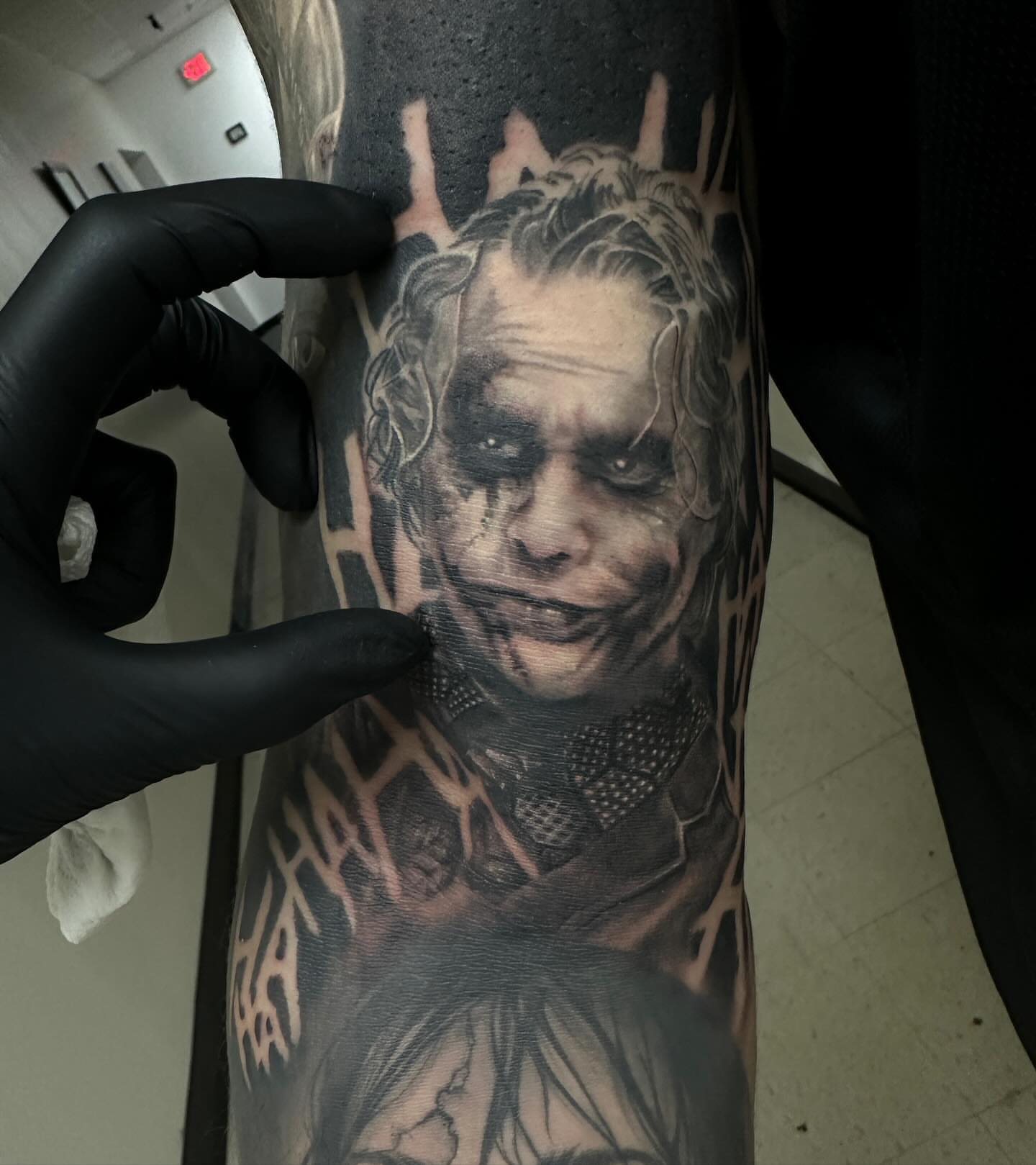 Joker realism tattoo on the forearm by Dale DeVille