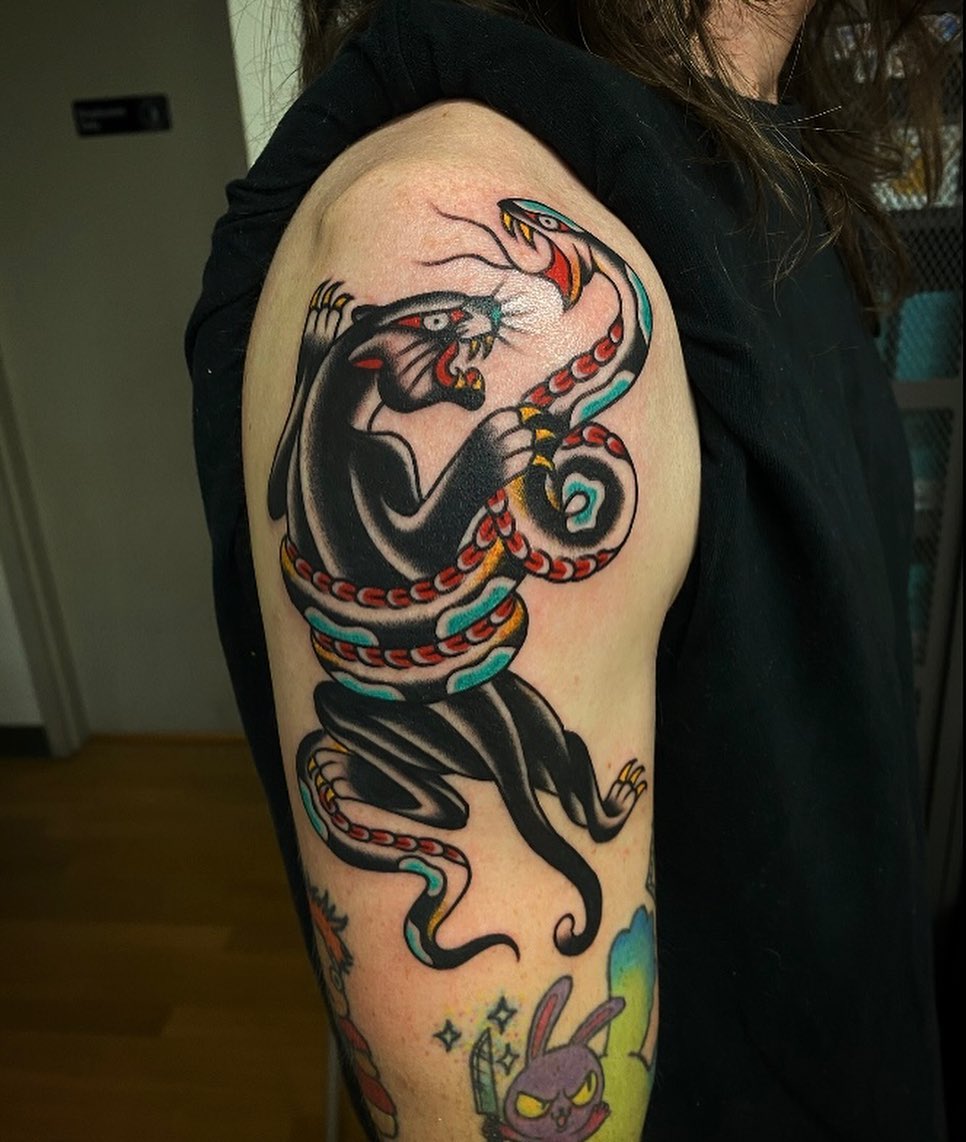 Panther and snake American traditional tattoo on the upper arm by Alan Pham, San Jose, California