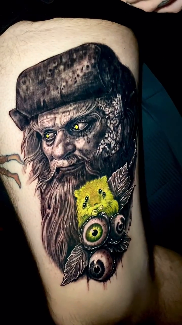 Man with eyes and leaves realism tattoo by Caitlyn Campbell