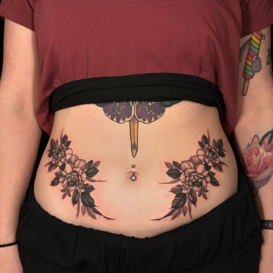 Floral arrangement black and grey tattoo on the torso by Sam Oakes