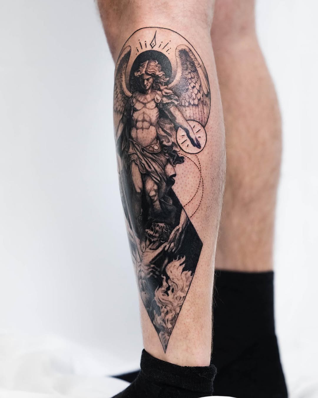 Angel and demon with flames realism tattoo on the calf by Ben Cisek