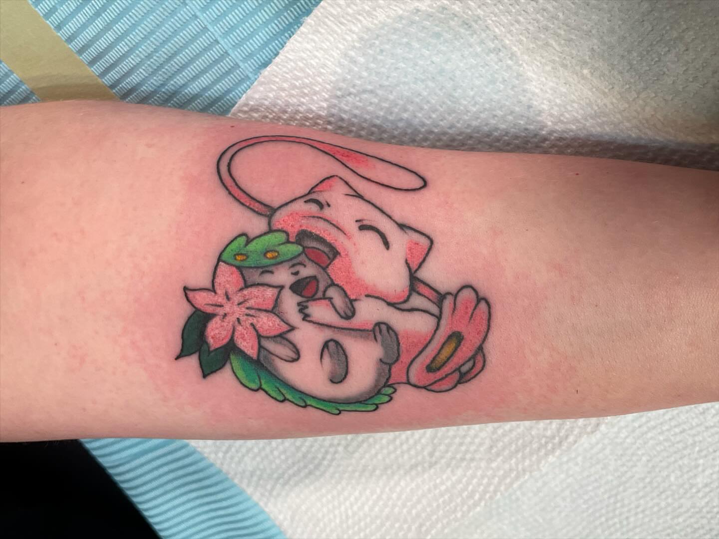 Dog and flower American traditional tattoo on the forearm by Kimberly Shordon