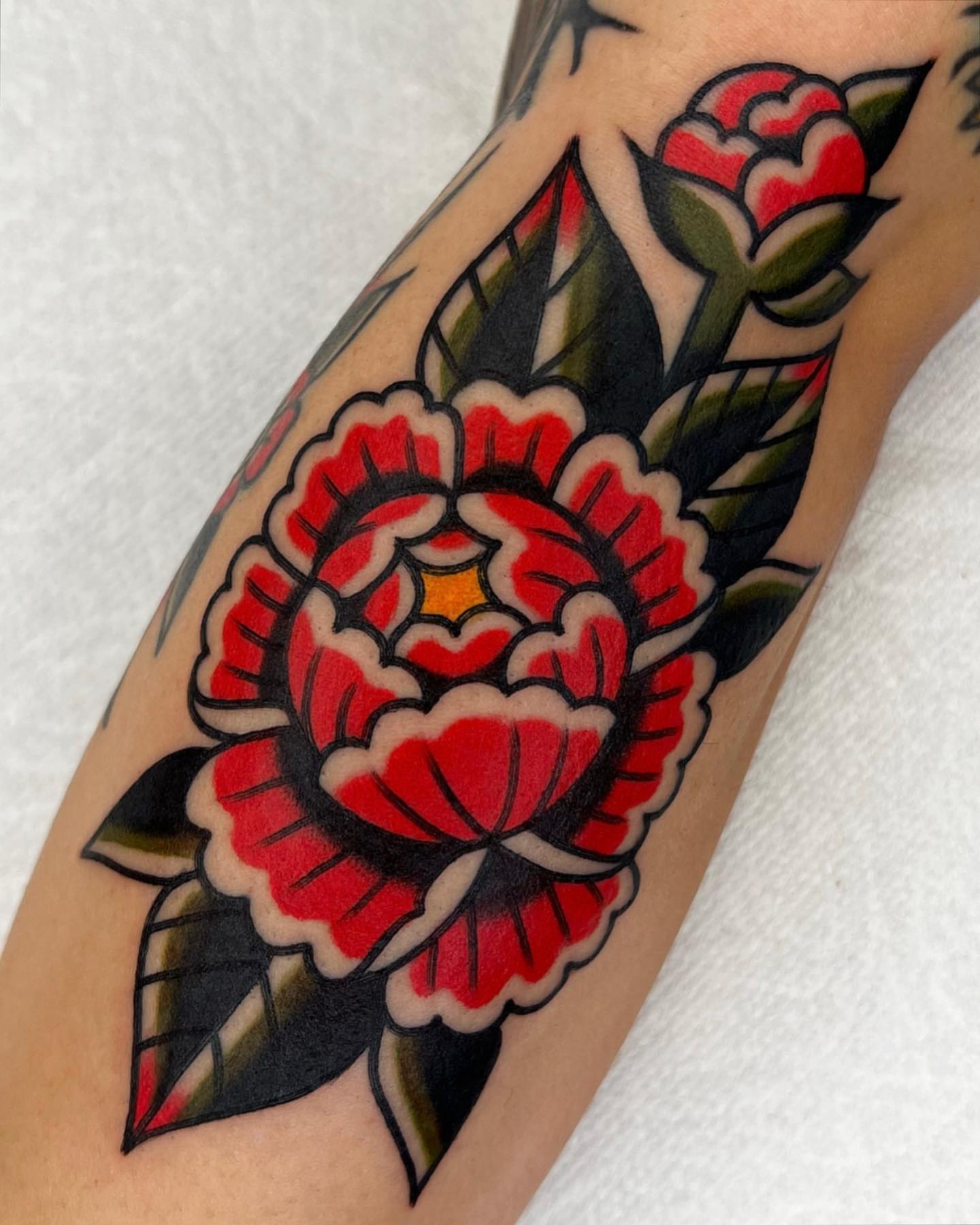 Peony American traditional tattoo on the forearm by Arturo Ledesma