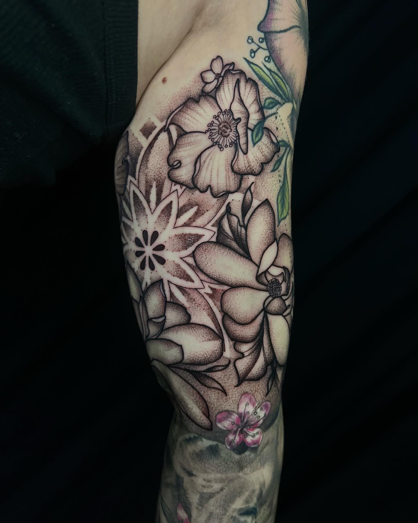 Floral arrangement dotwork tattoo on the forearm by Pam Sanders