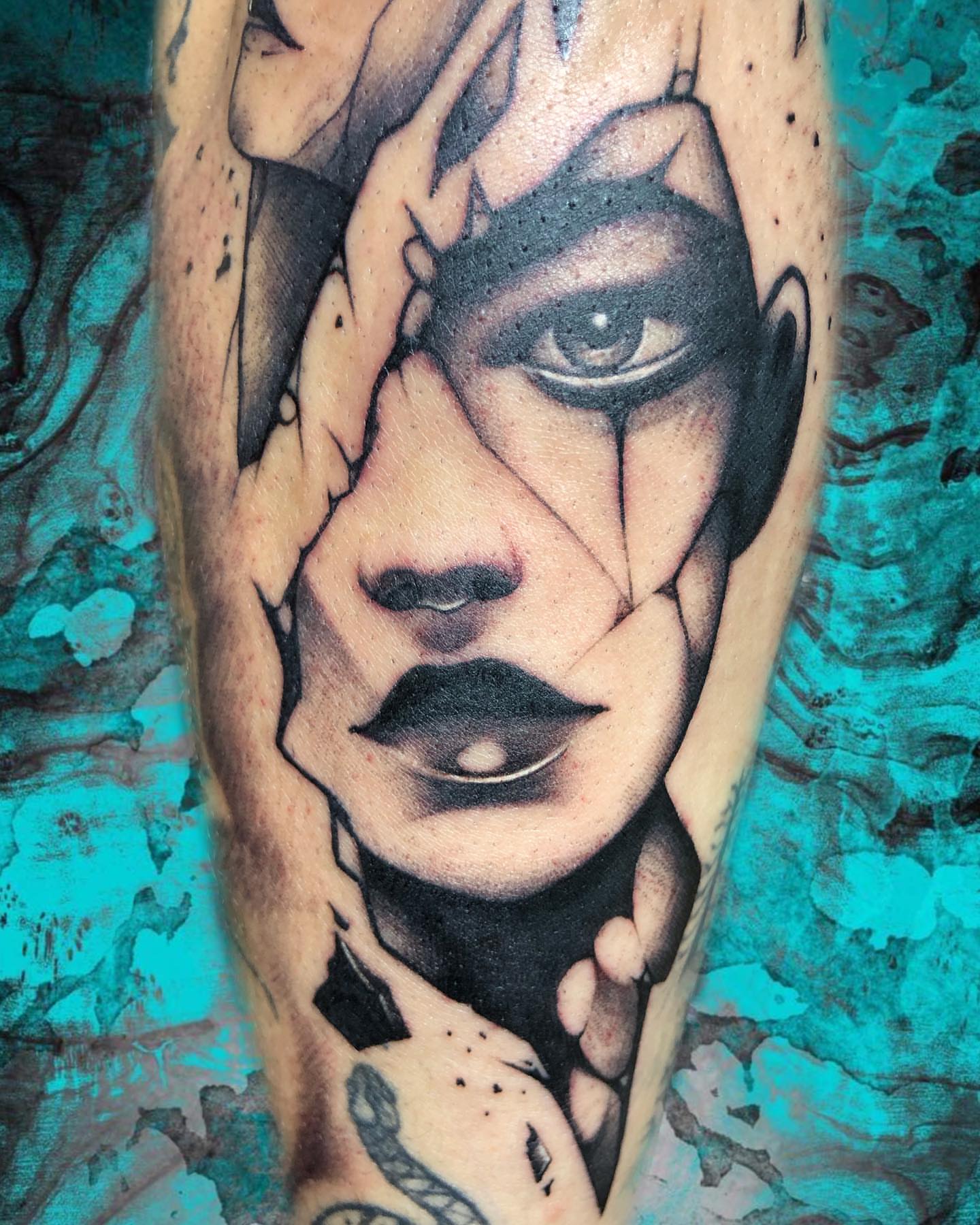 Abstract face geometric tattoo on the forearm by Luis Chauta