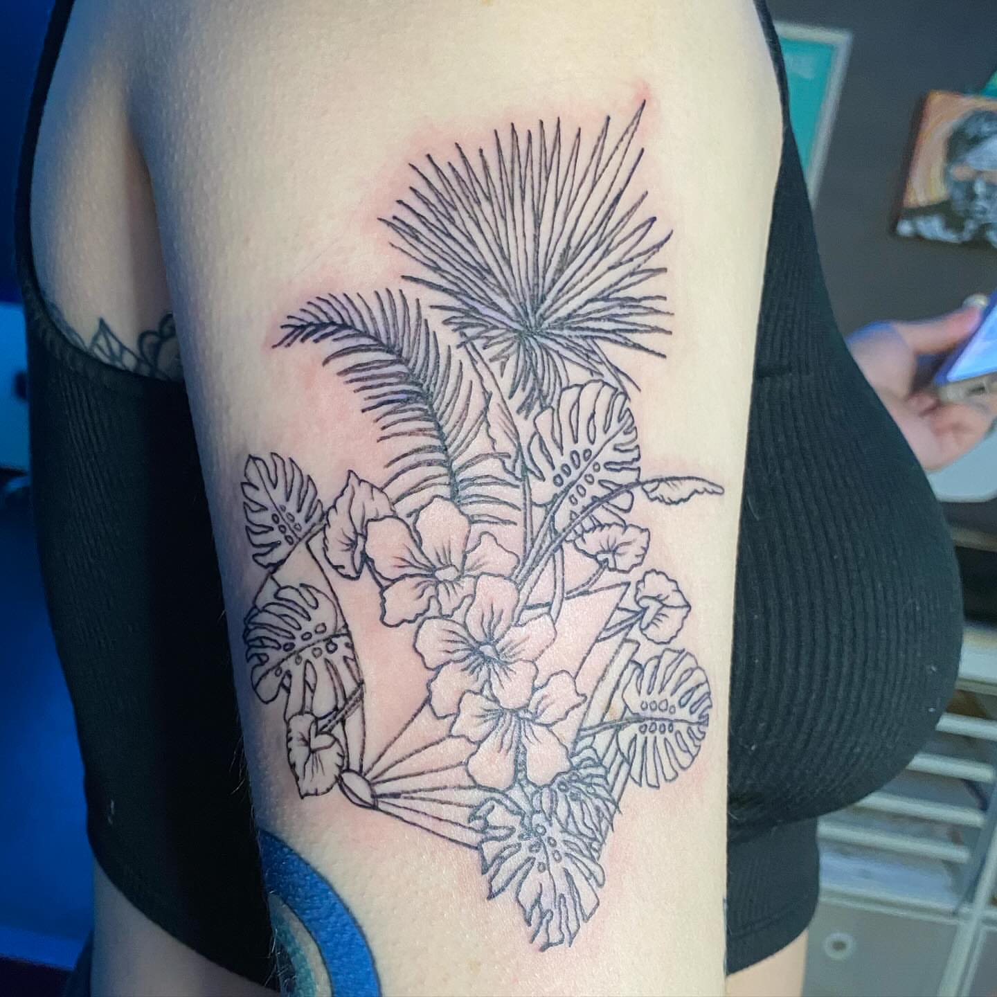 Tropical floral arrangement black and grey tattoo on the thigh by Tesla Kohl