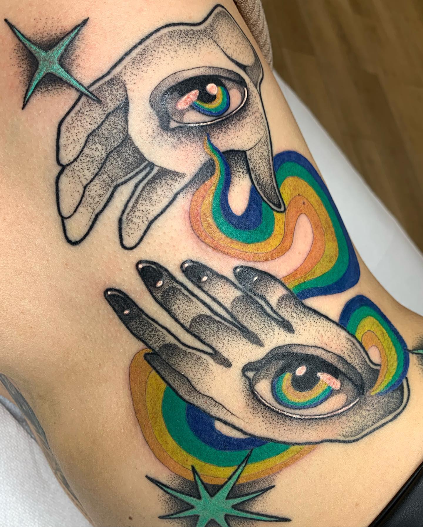 Hands with eyes dotwork tattoo on the shoulder by Carly Zehring