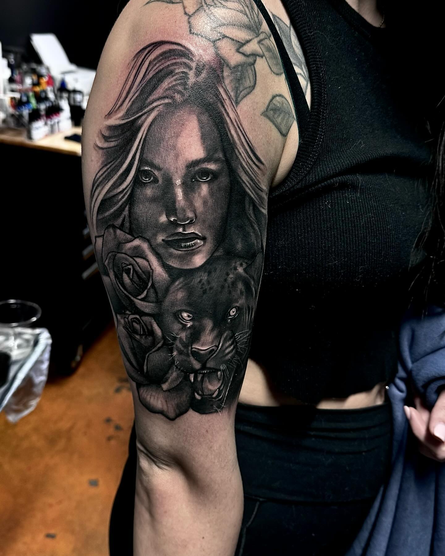 Woman with roses and panther realism tattoo on the forearm by Tattoos by Dave