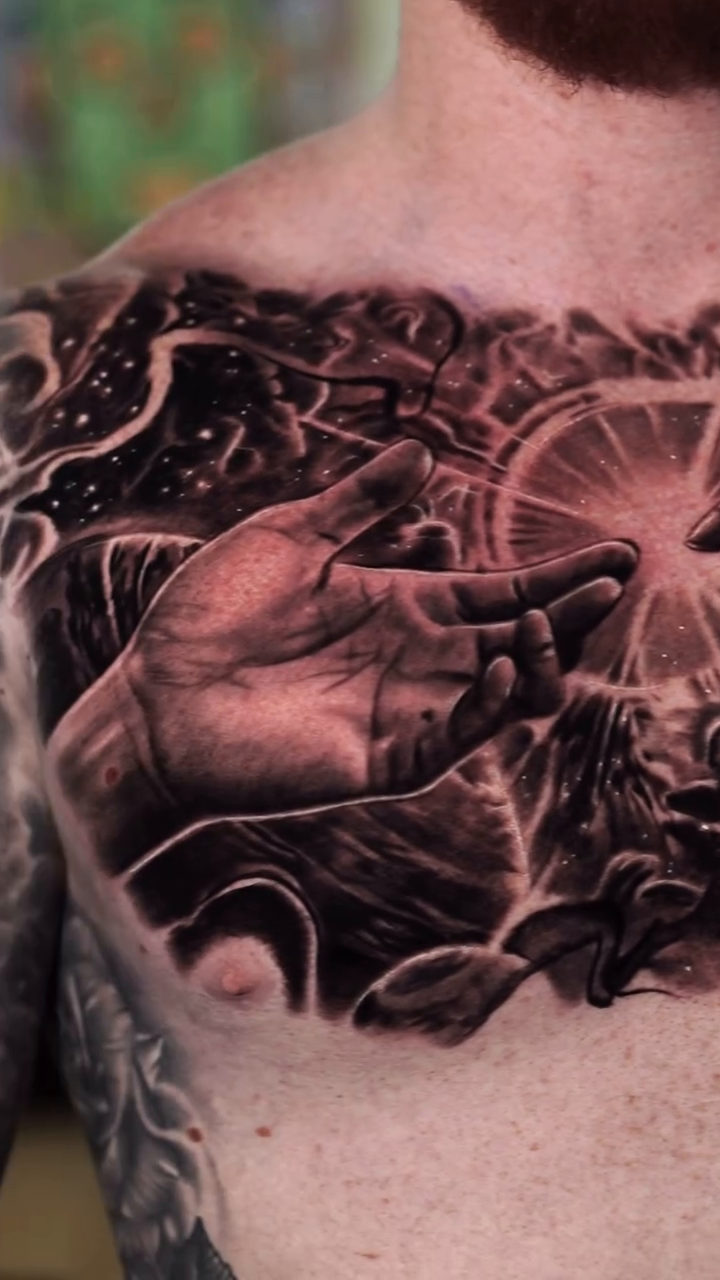 Cosmic scene with hands realism tattoo by Ryan Gage Gonzalez