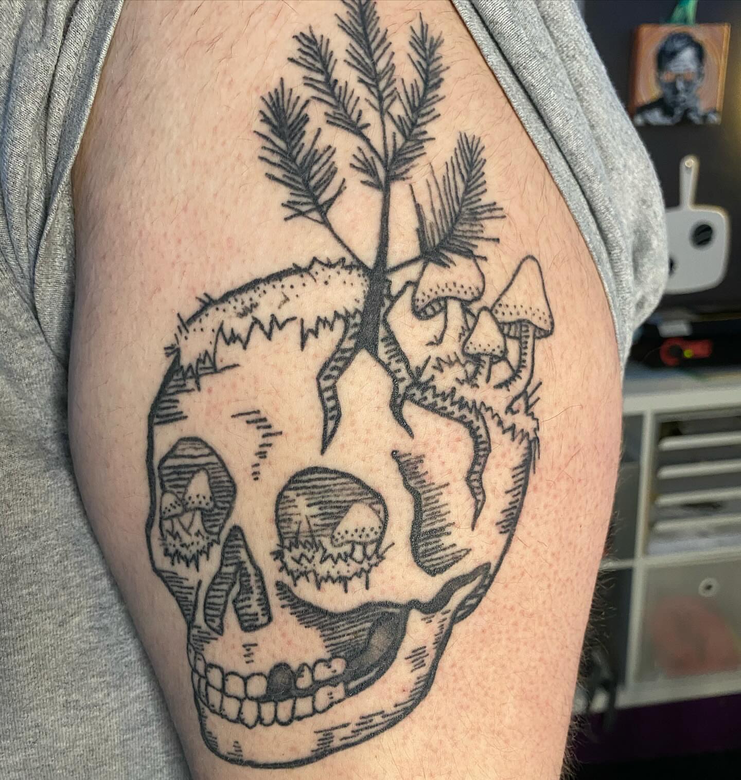 Skull with mushrooms and tree geometric tattoo on the upper arm by Tesla Kohl