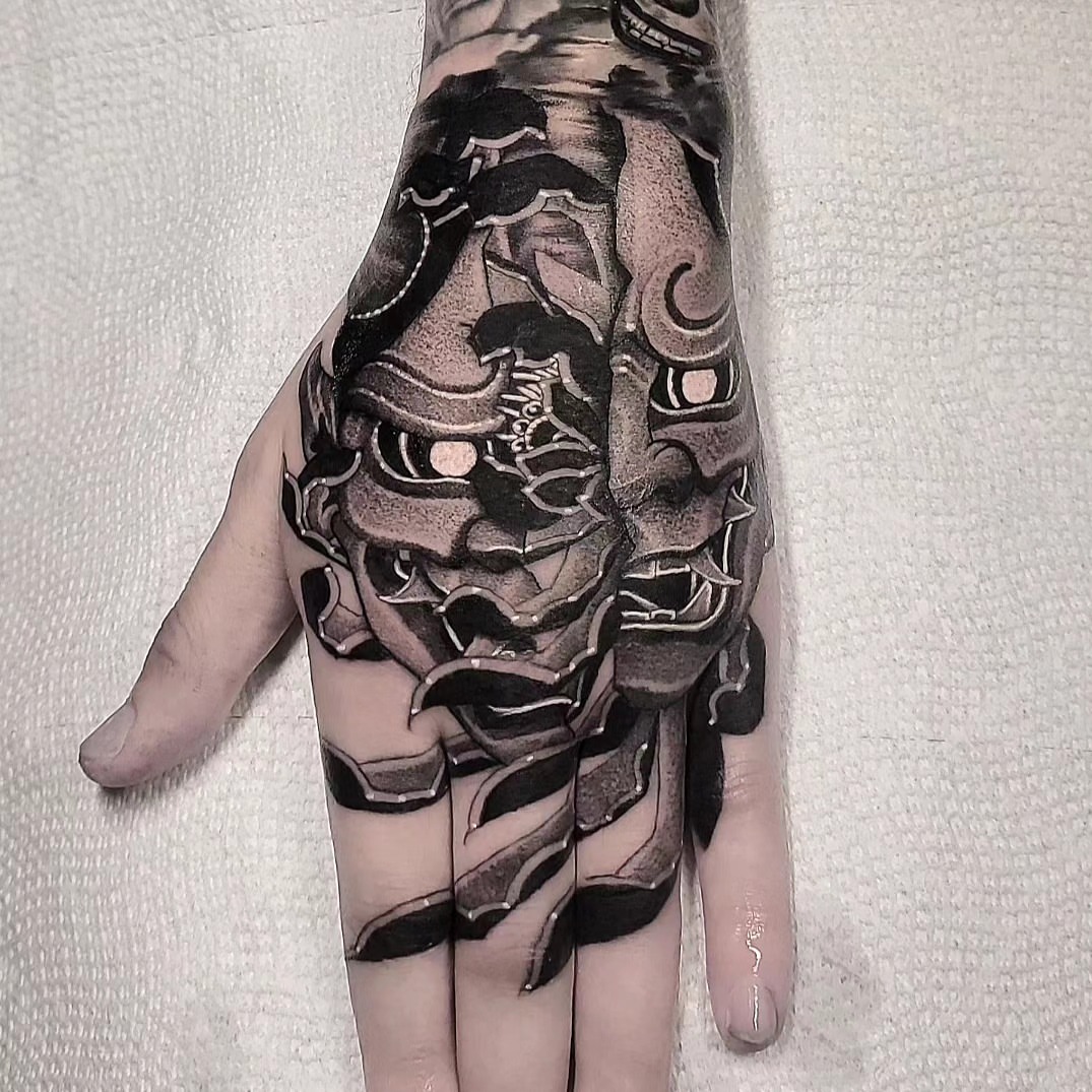 Mask geometric tattoo on the hand by miami tattoo artist