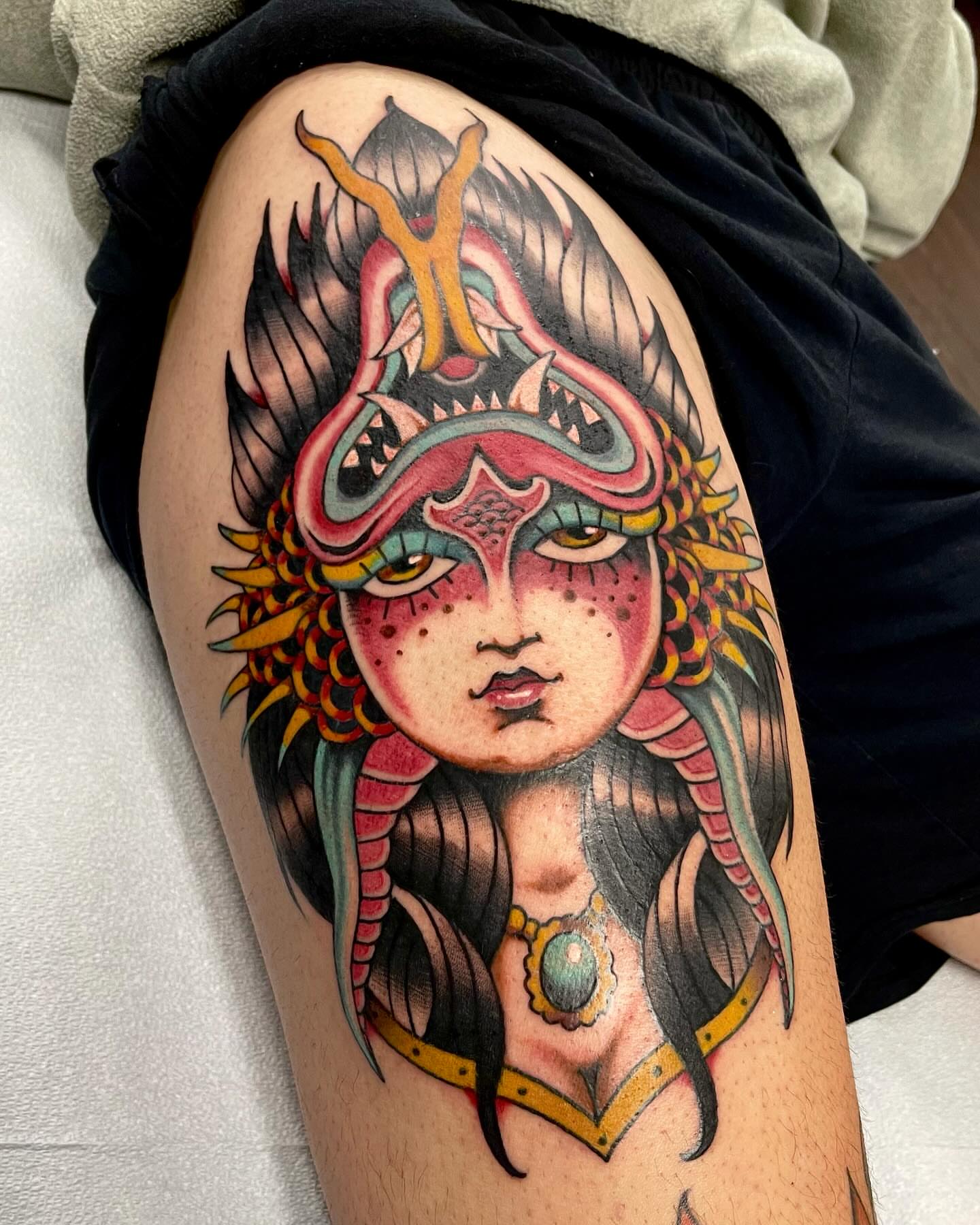 Indian headdress American traditional tattoo on the thigh by Dave Shurman