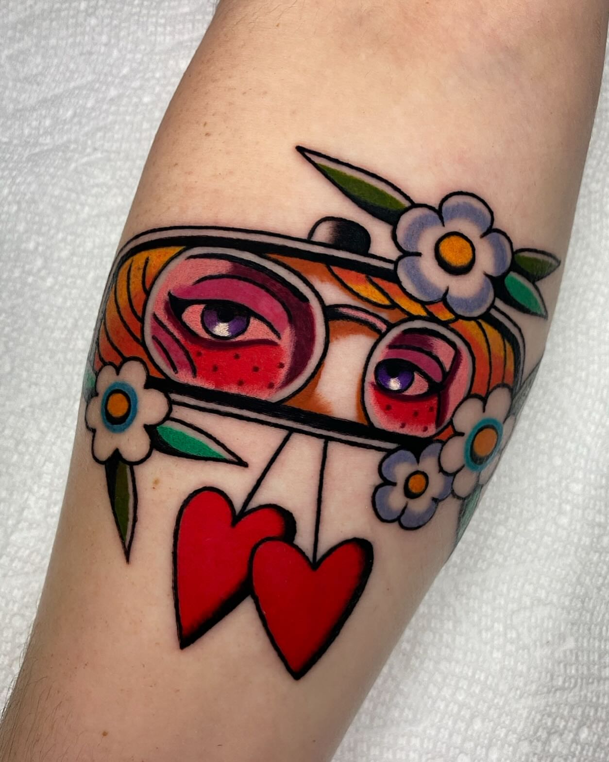 Eye and floral crown American traditional tattoo on the forearm by Mitch Hoggard
