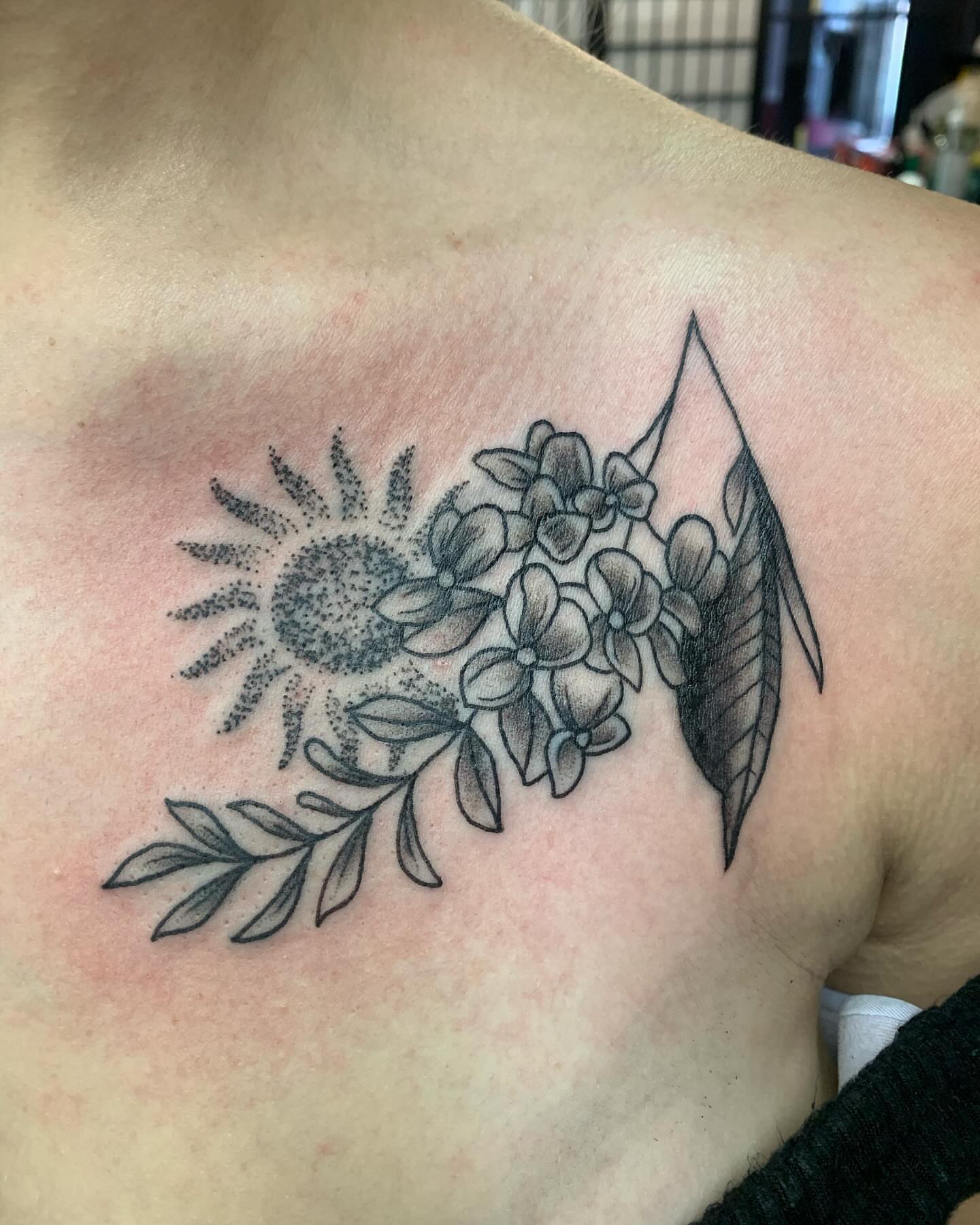 Sunflower and flowers dotwork tattoo on the shoulder by Cody Marl