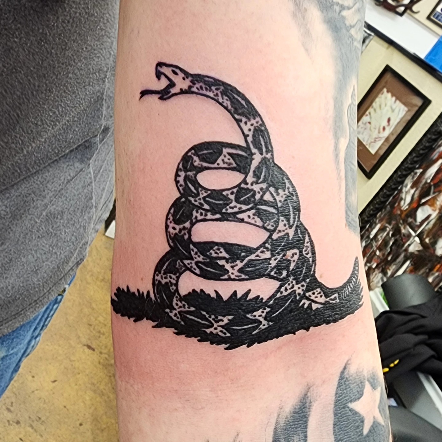 Snake black and grey tattoo on the forearm by @thedevilspaintbrush_