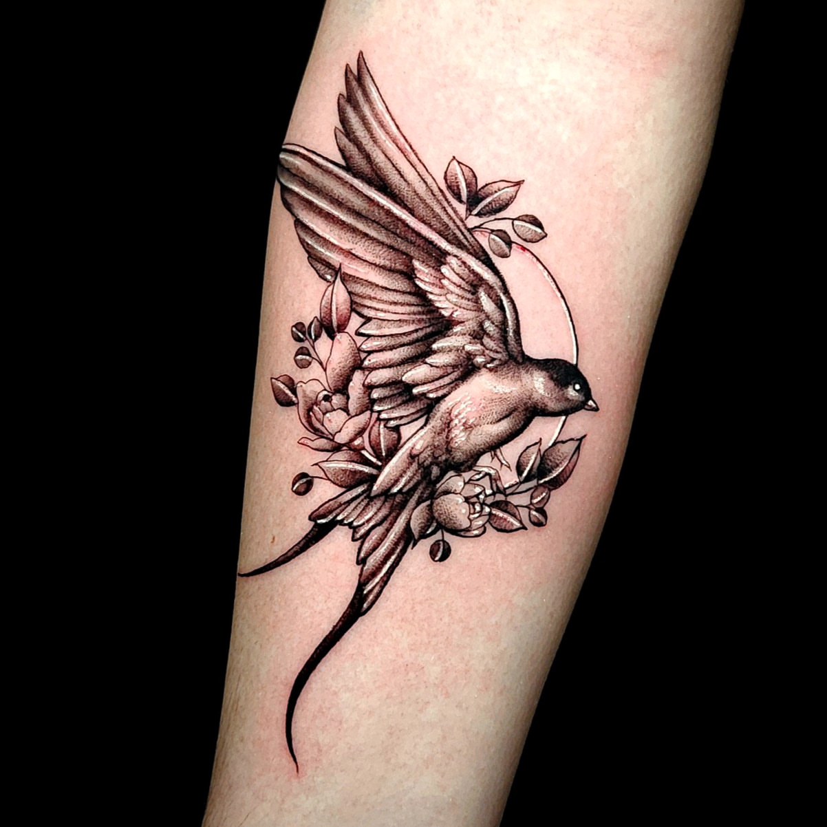 Swallow and flowers black and grey tattoo on the forearm by Sydney Paige, Mentor, Ohio