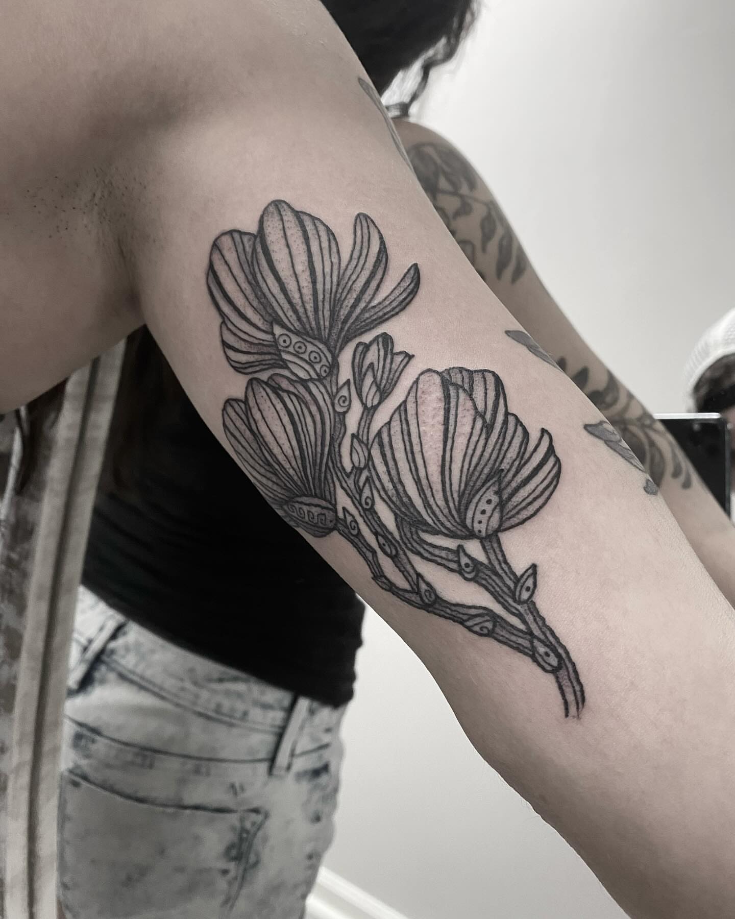 Flowers black and grey tattoo on the forearm by Alex Shakuto Tattoo