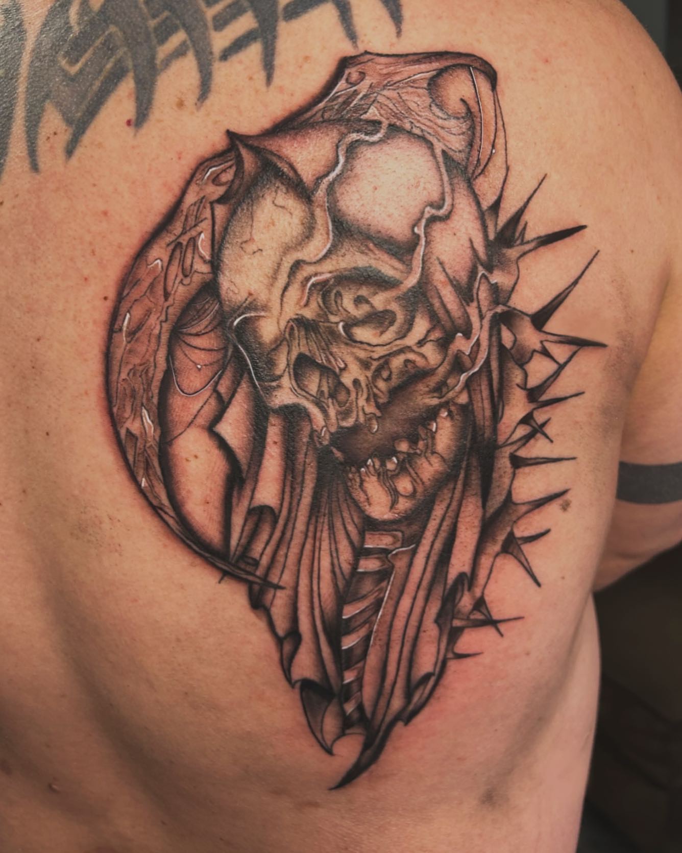Skull dark realism tattoo on the shoulder by Tattoo Artist