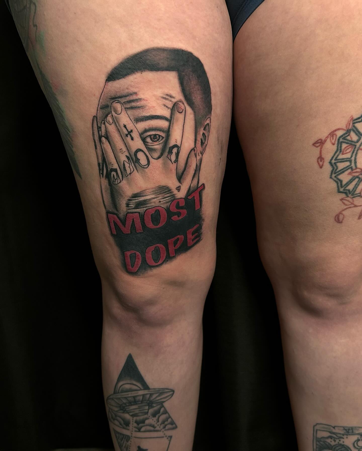 Hands covering face American traditional tattoo on the thigh by Alyssa Turner