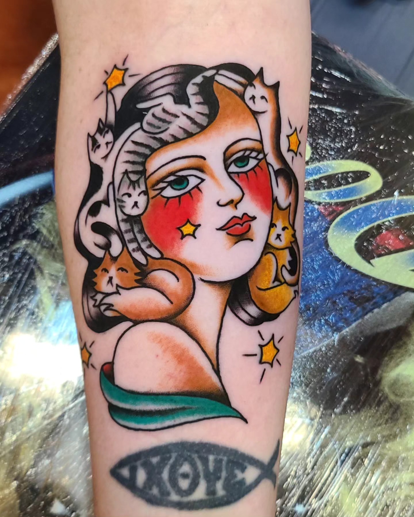 Woman with cats American traditional tattoo on the forearm by Angie Isbell