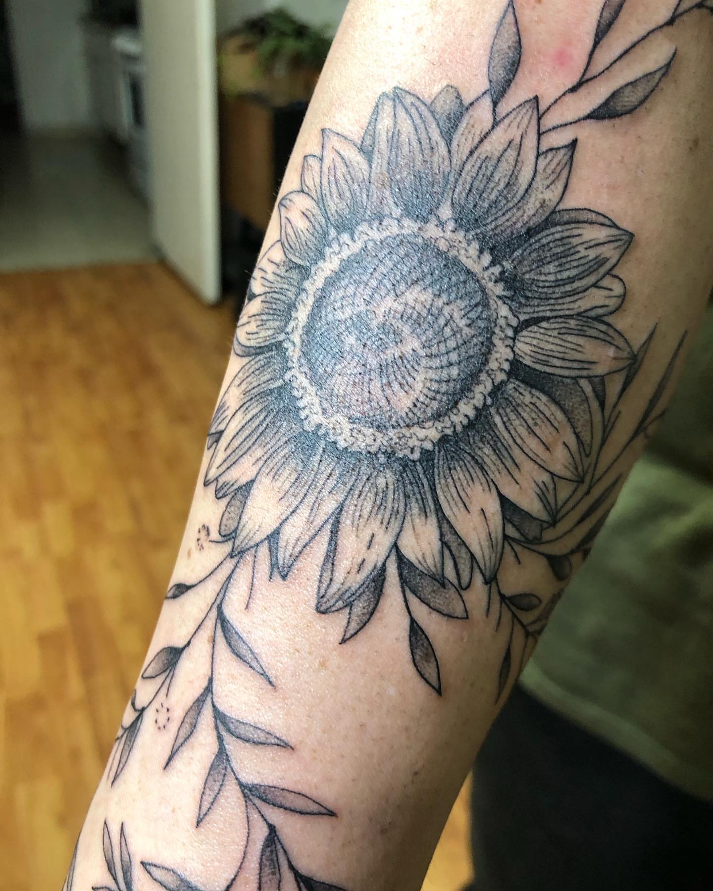 Sunflower black and grey tattoo on the forearm by Barro