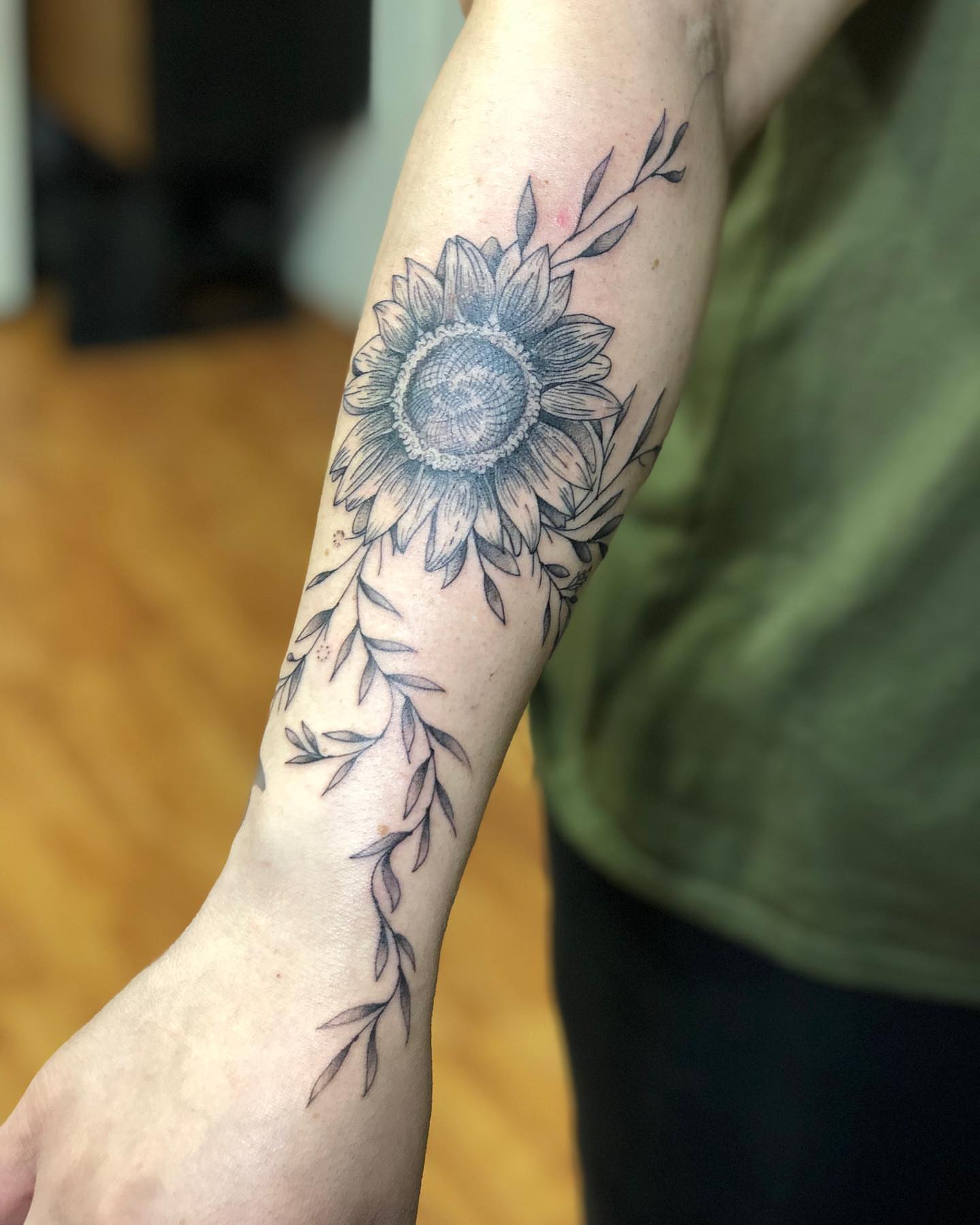 Sunflower black and grey tattoo on the forearm by Barro
