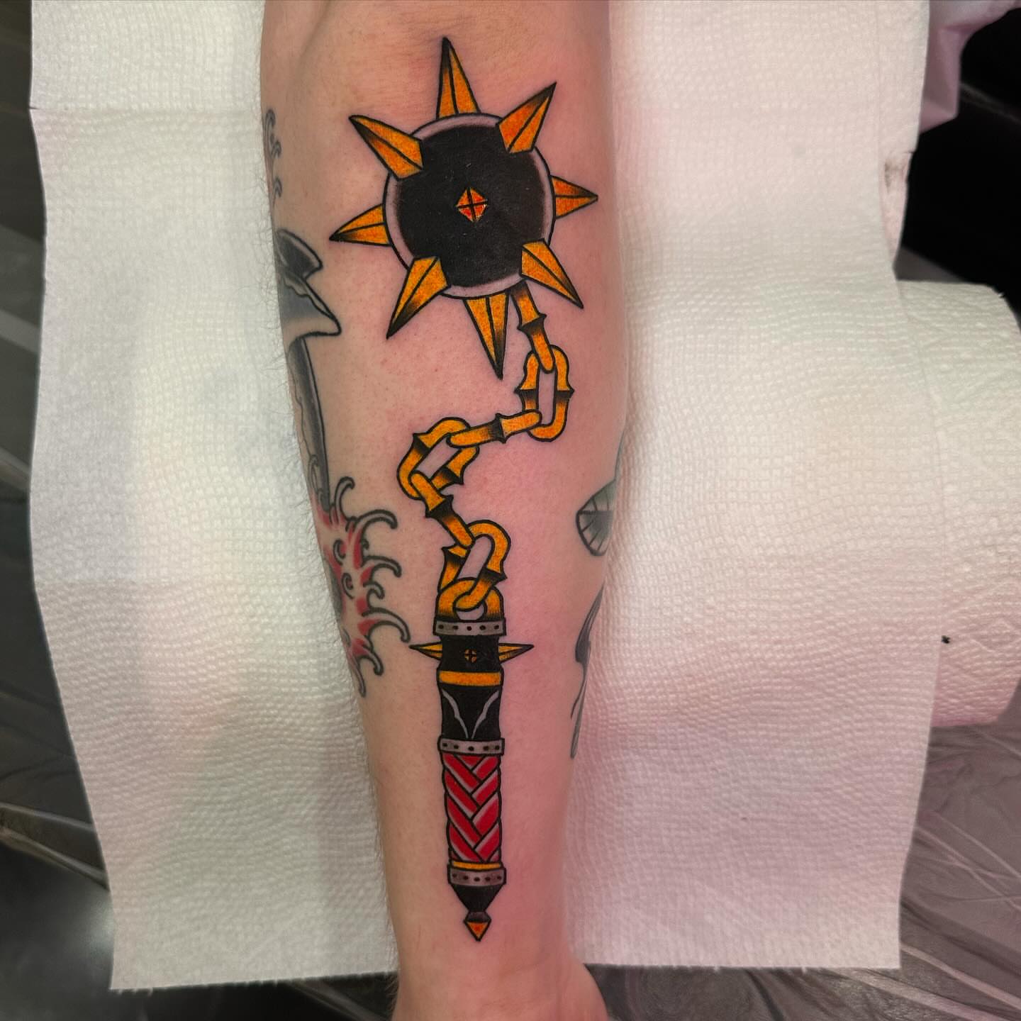 Sun and chain American traditional tattoo on the forearm by 𝕯𝖗𝖊𝖜 𝕲𝖎𝖑𝖊𝖘 𝕵𝖆𝖙𝖙𝖔𝖔, Addison, Texas