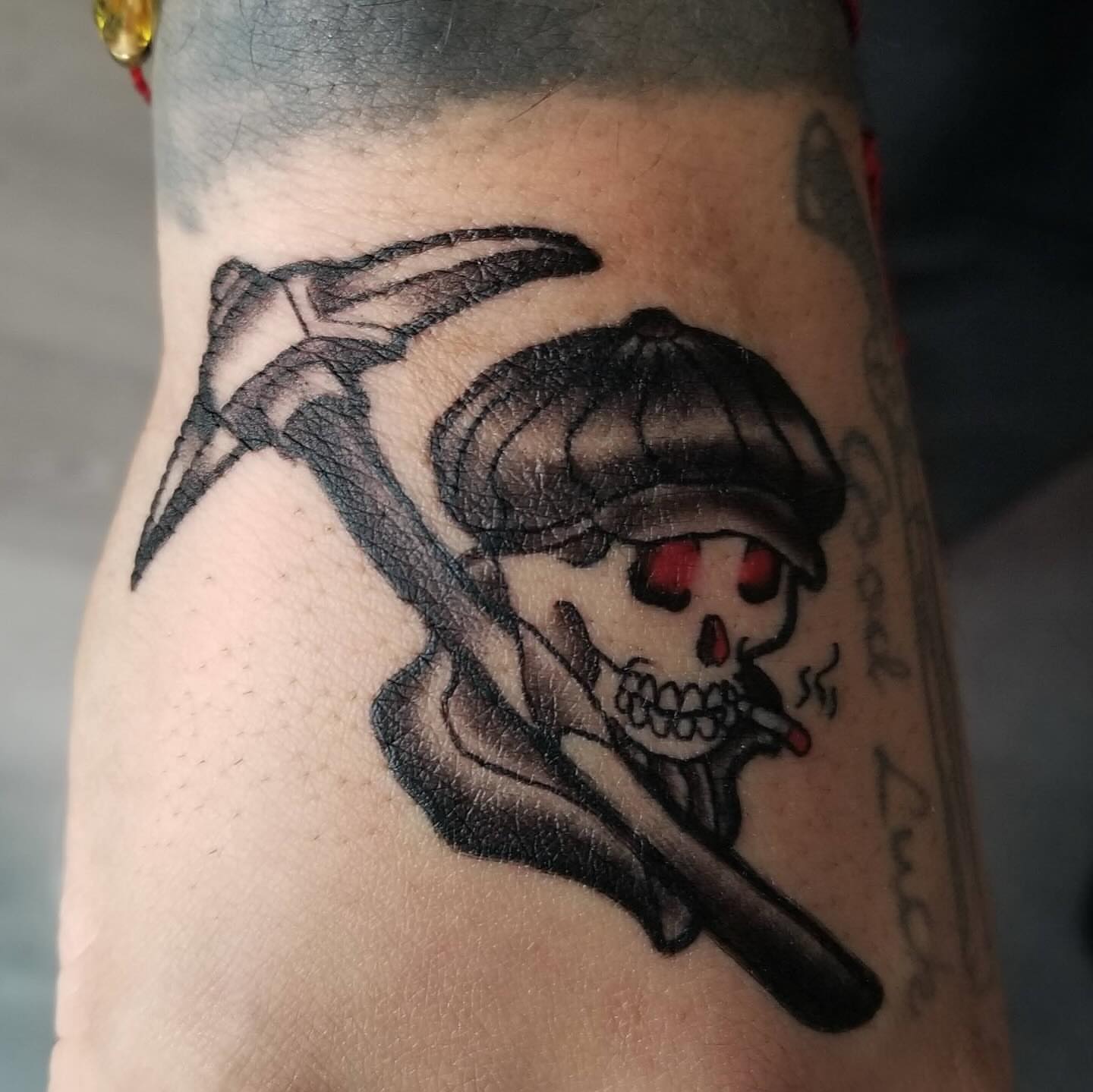 Skull smoking cigar American traditional tattoo on the forearm by J. Arturo Laparra