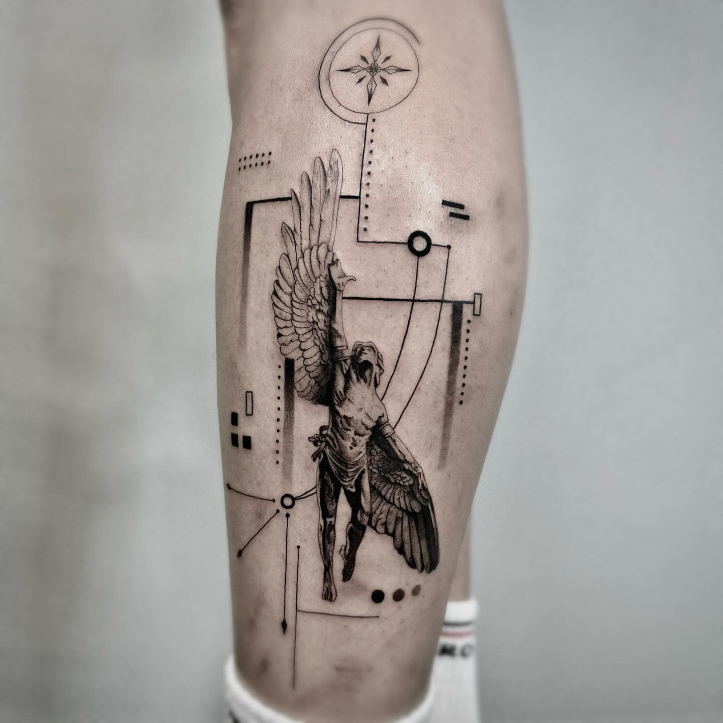 Winged angel geometric tattoo on the forearm by Seraph Geometry