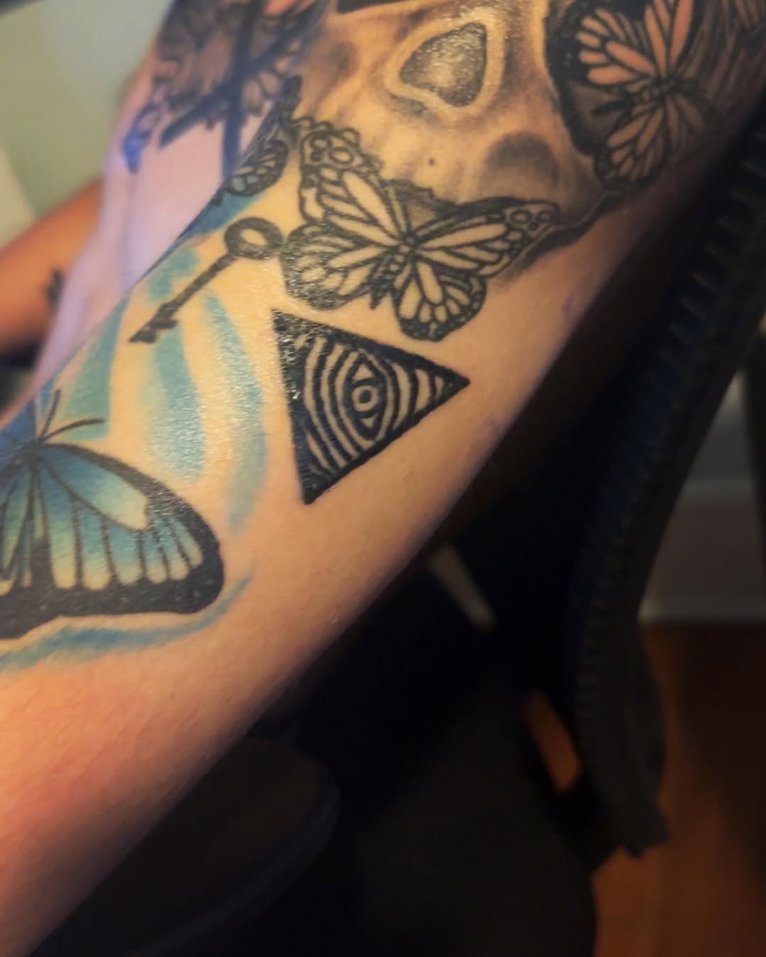 Triangle with concentric circles and butterflies tattoo on the forearm by Silky Inks NJ 201, North Haledon, New Jersey