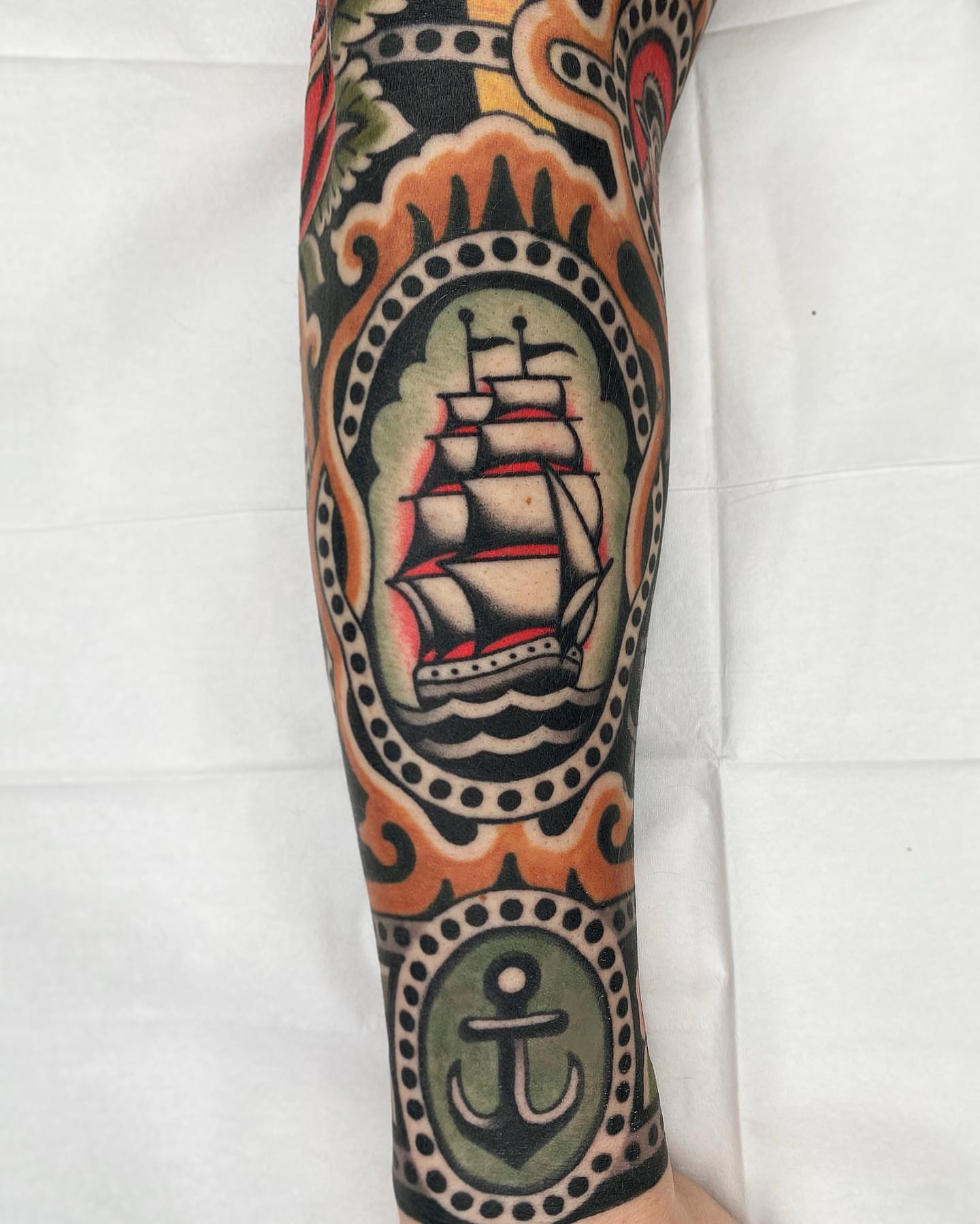 Ship and anchor American traditional tattoo on the forearm by Wes Hoffman