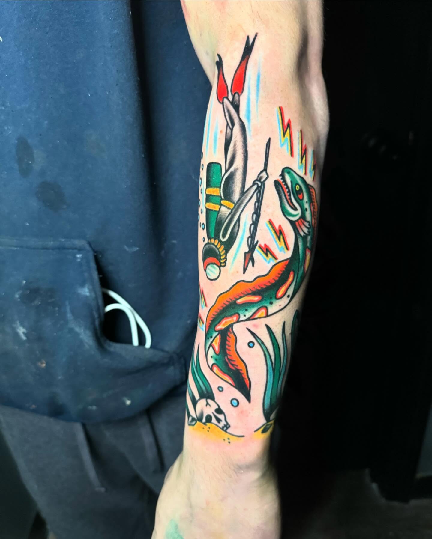 Diver and dinosaur American traditional tattoo on the forearm by Nate Masi