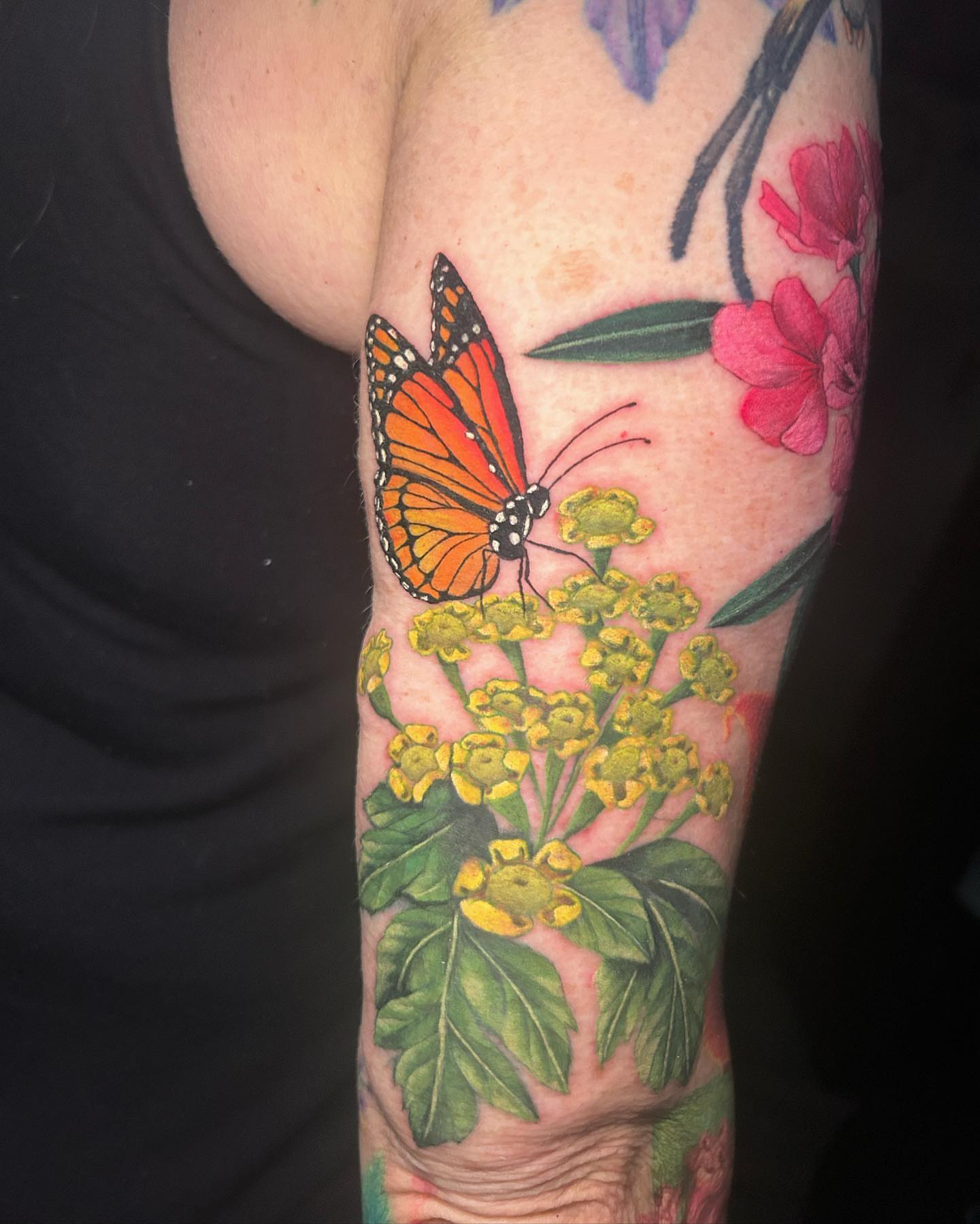Butterfly and flowers realism tattoo on the forearm by Tattertot