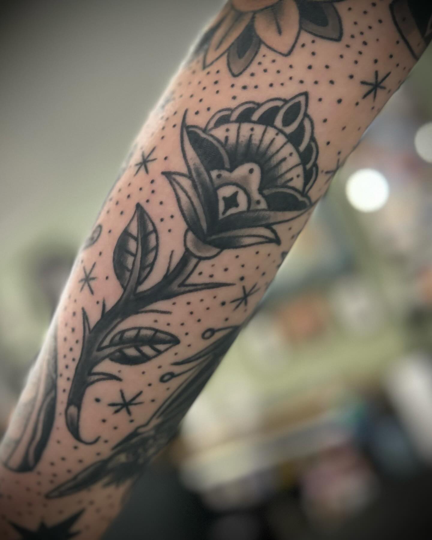 Flower American traditional tattoo on the forearm by Alex Fannin