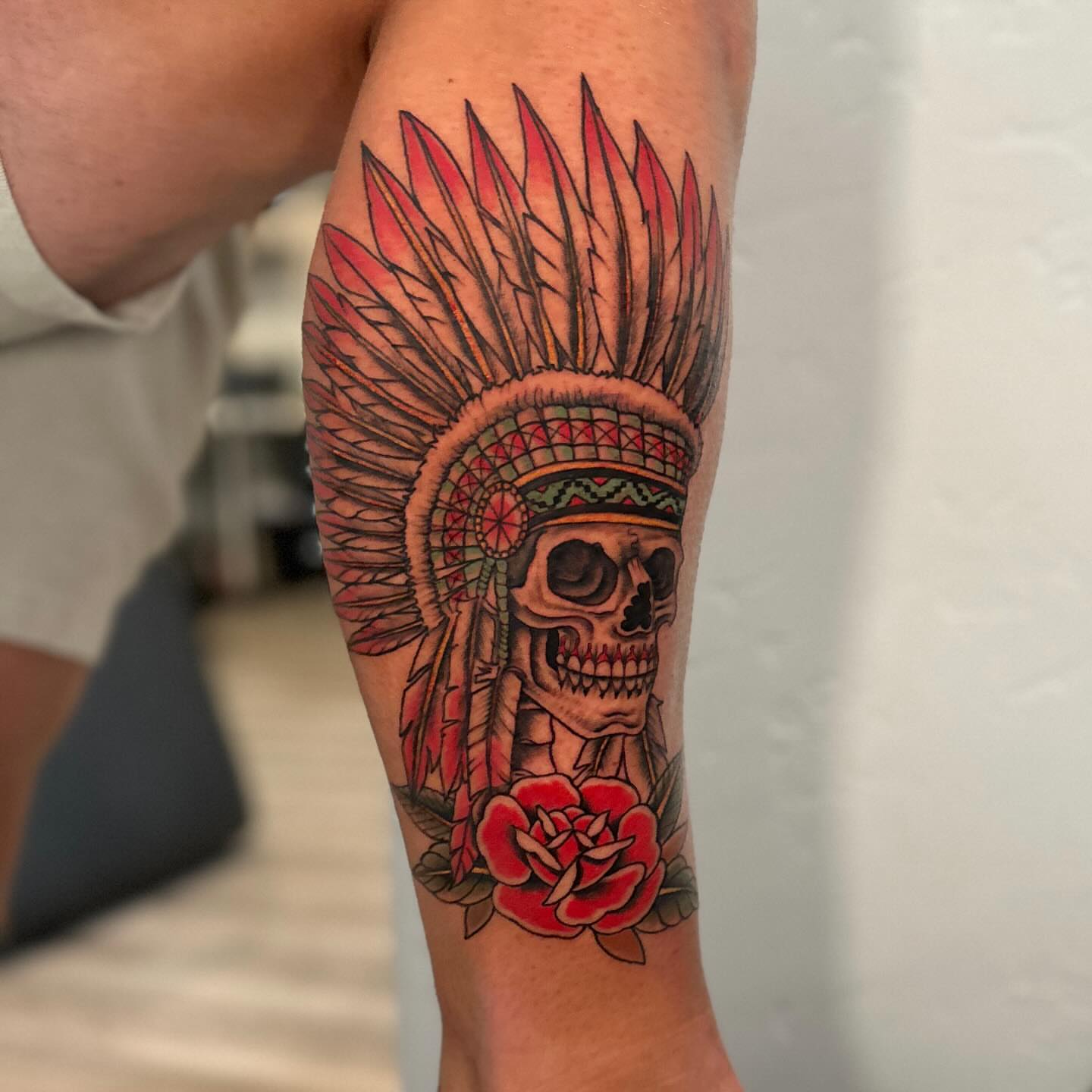 Skull with headdress American traditional tattoo on the forearm by Stephen Hansen