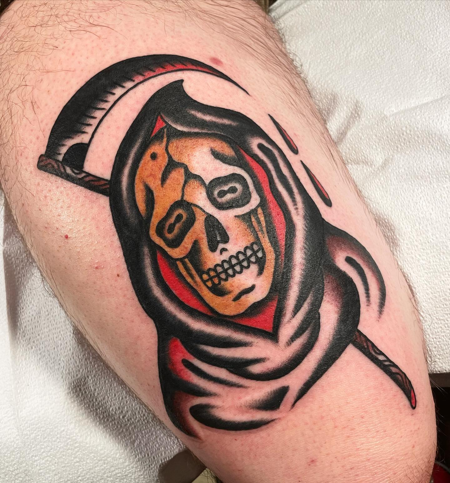 Grim reaper American traditional tattoo on the thigh by Mike Hudgins