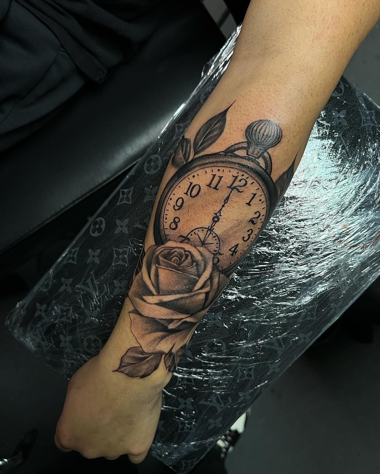 Clock and rose realism tattoo on the forearm by Smuk One
