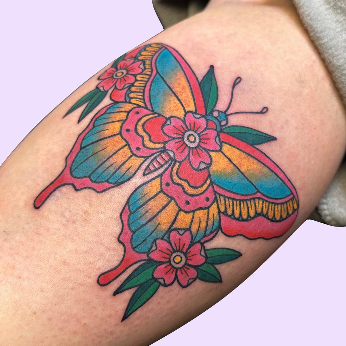 Butterfly and flowers American traditional tattoo on the forearm by Gabby Tolley🌛