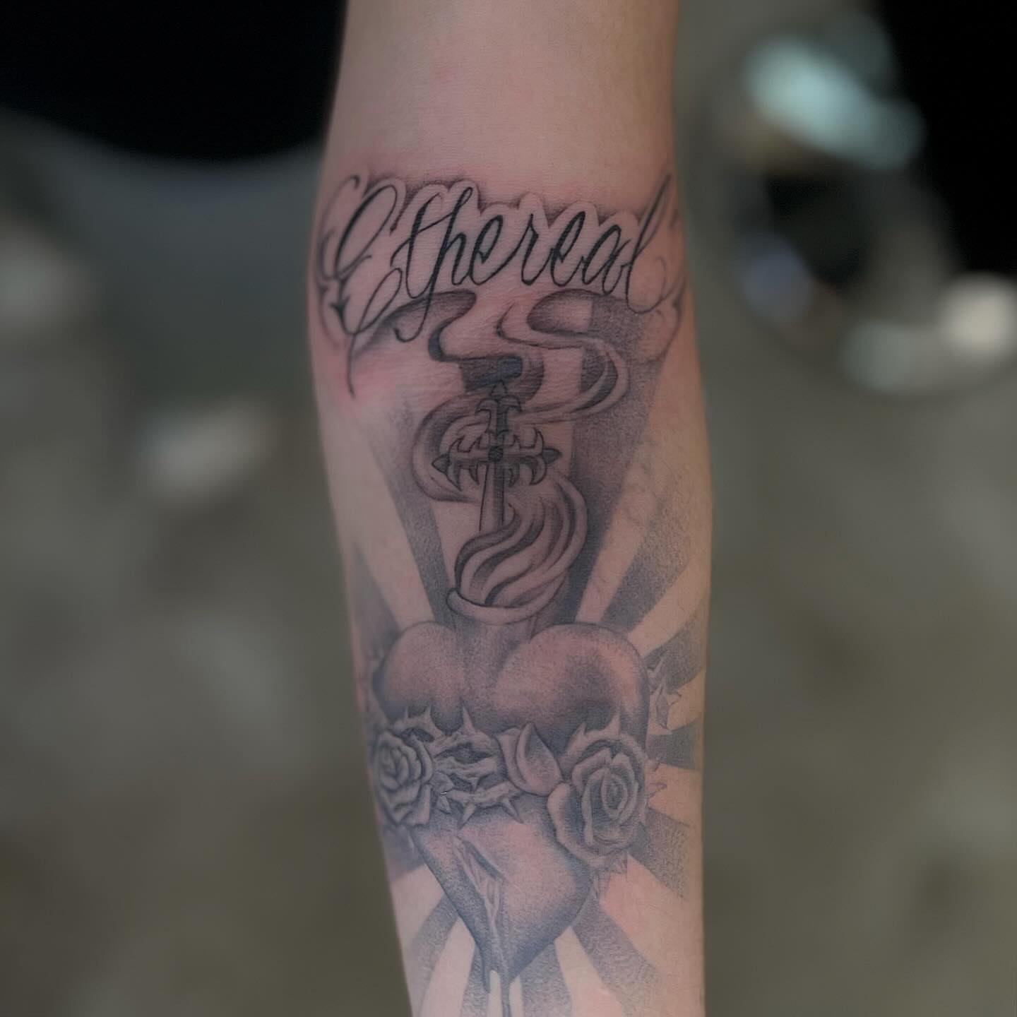Sword and roses realism tattoo on the forearm by Jocelyn