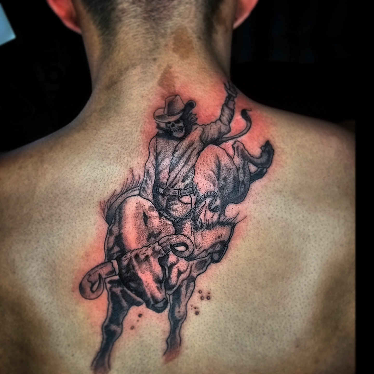 Cowboy riding bull realism tattoo on the back by TattoosbyPhatboi