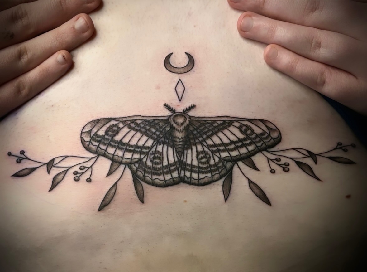 Moth black and grey tattoo on the torso by Tattoos by Marcy