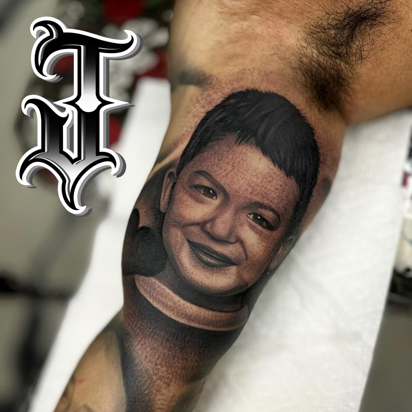Portrait realism tattoo on the forearm by Joseph Alvarado