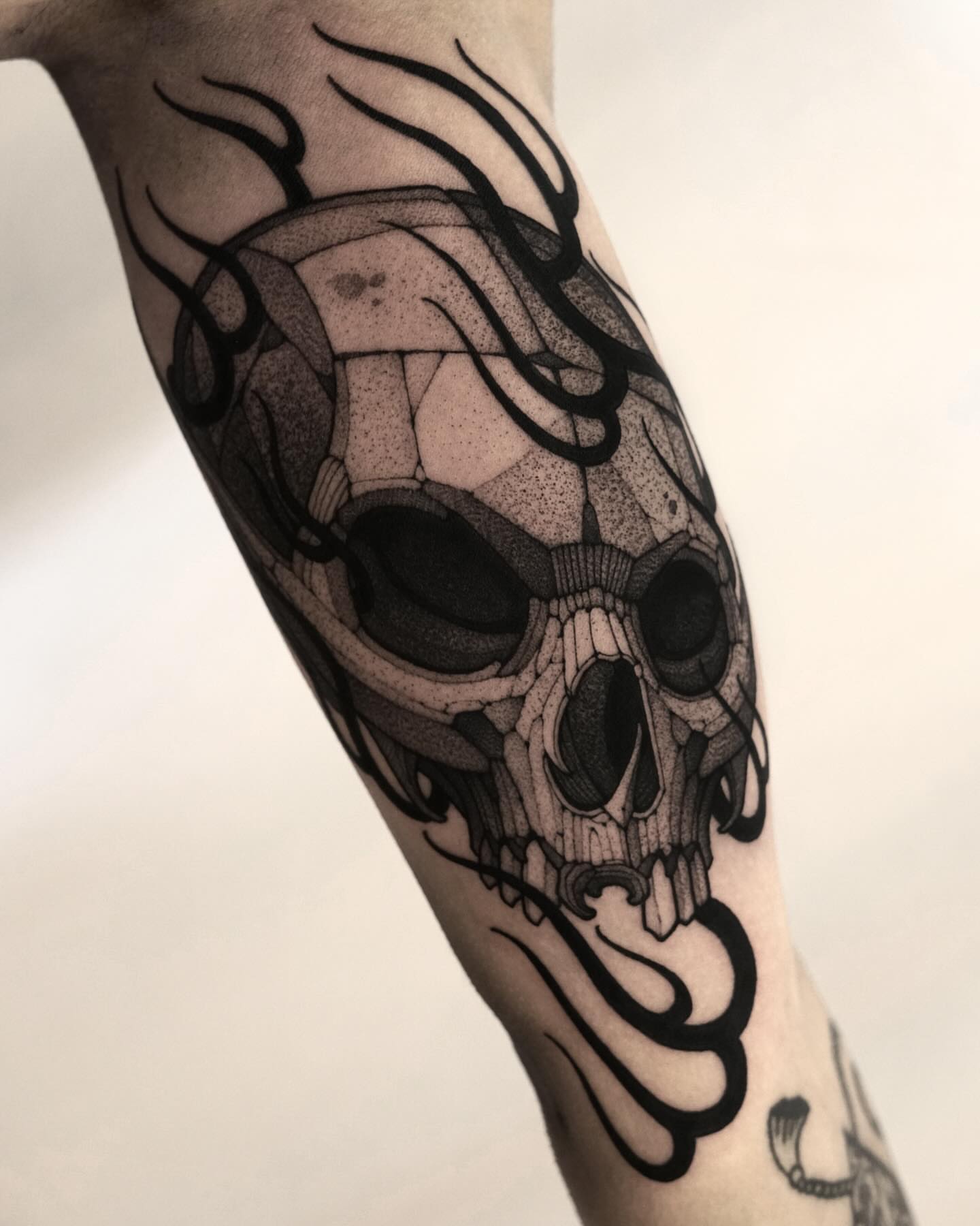Skull dotwork tattoo on the forearm by Max LaCroix