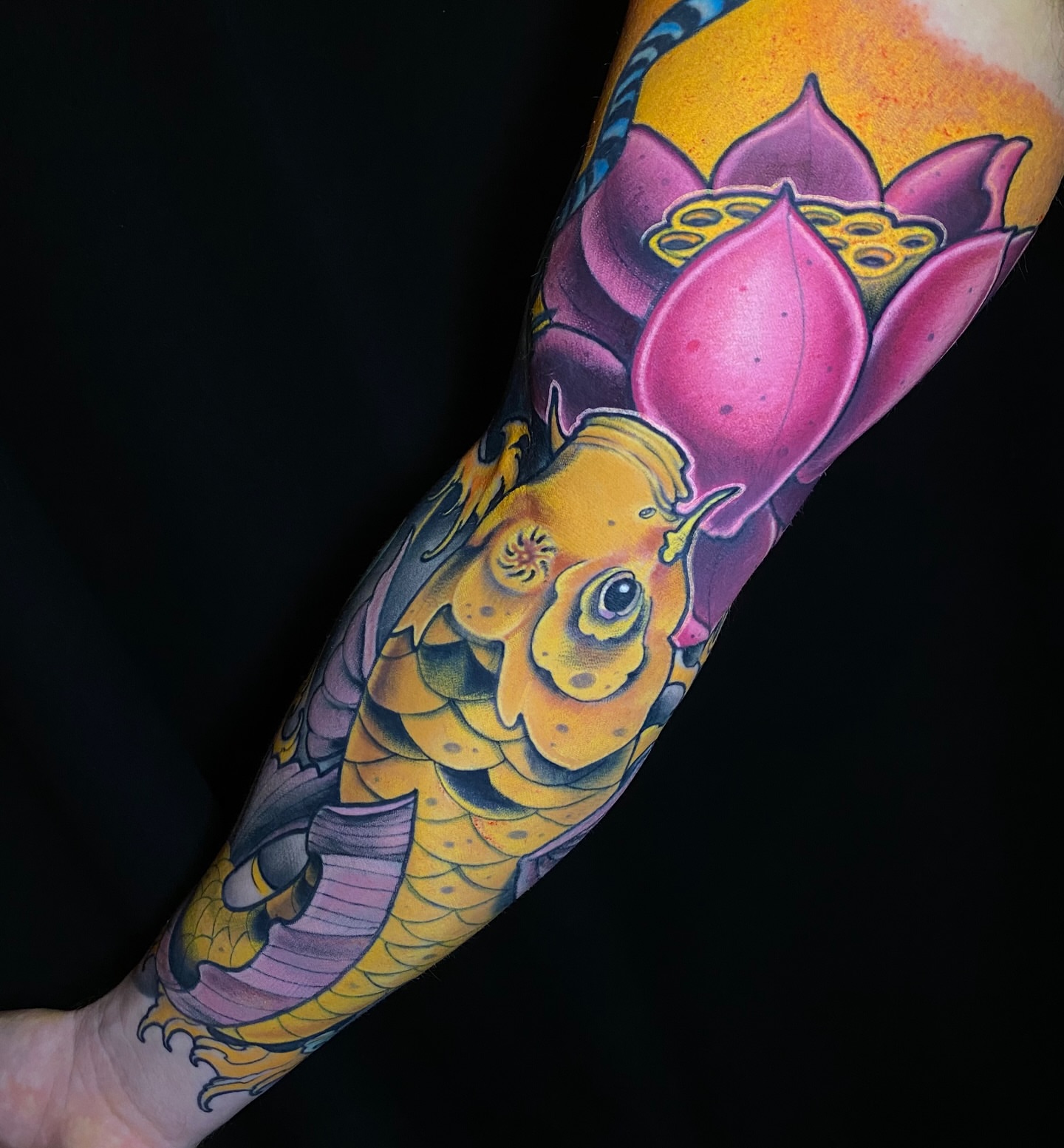 Koi fish and lotus flower new school tattoo on the forearm by Ty Pallotta, Austin, Texas