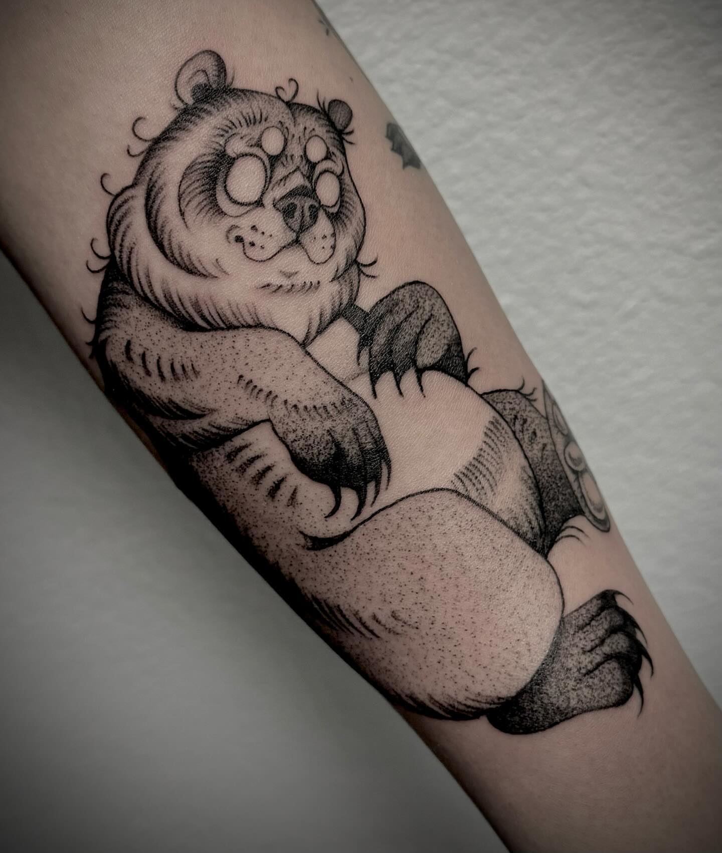 Panda dotwork tattoo on the forearm by Melanie