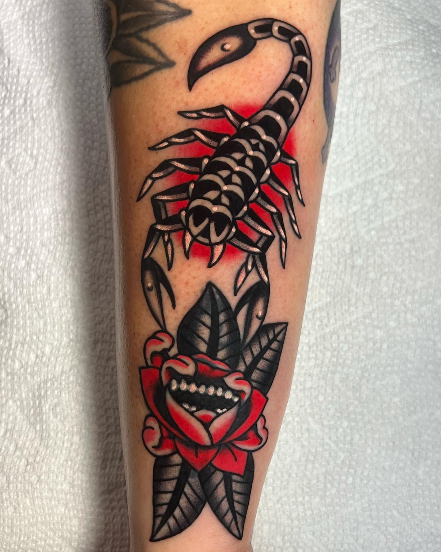 Scorpion and rose American traditional tattoo on the forearm by Brice Hamm