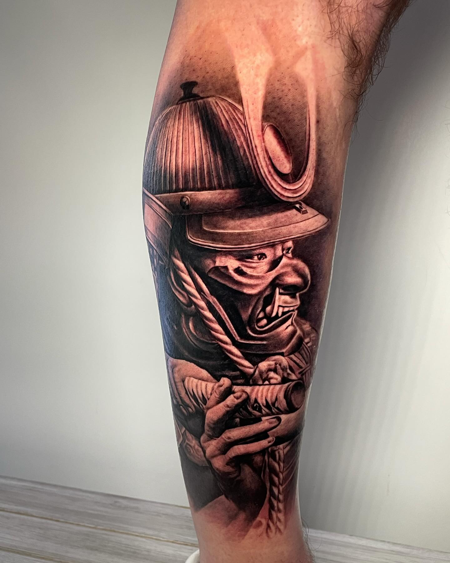 Firefighter helmet realism tattoo on the forearm by Justin Reid, San Jose, California