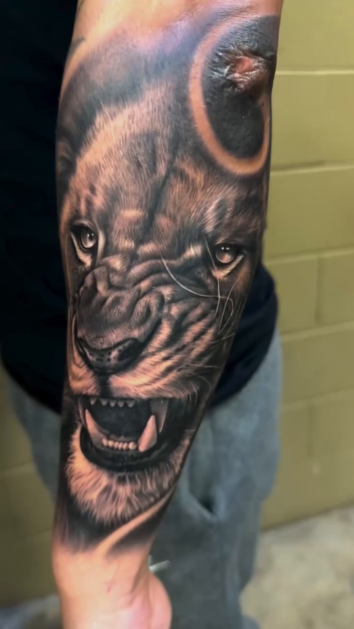 Lion face realism tattoo by Ana Reyes